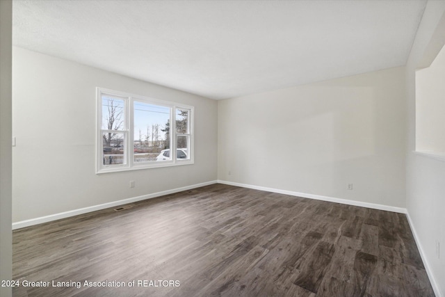 empty room featuring dark wood-type flooring