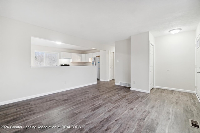 unfurnished living room featuring wood-type flooring