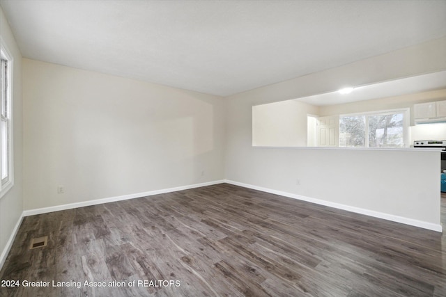 empty room with dark wood-type flooring