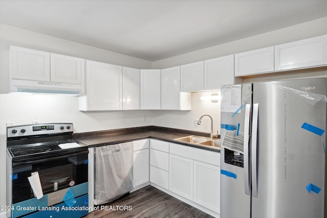 kitchen featuring appliances with stainless steel finishes, white cabinetry, dark wood-type flooring, and sink