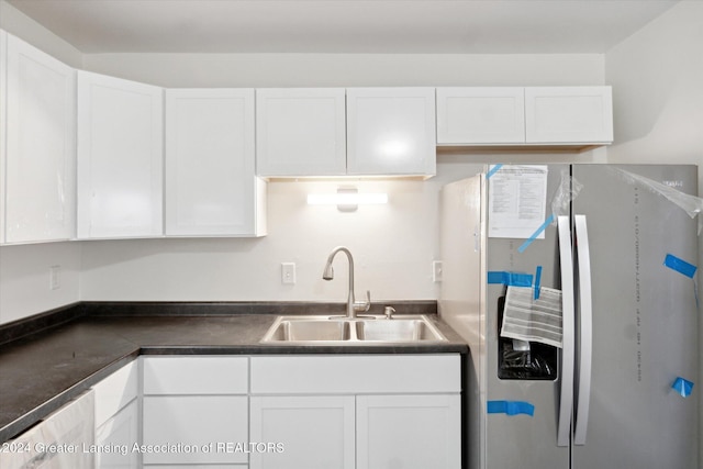 kitchen with stainless steel fridge with ice dispenser, sink, and white cabinets