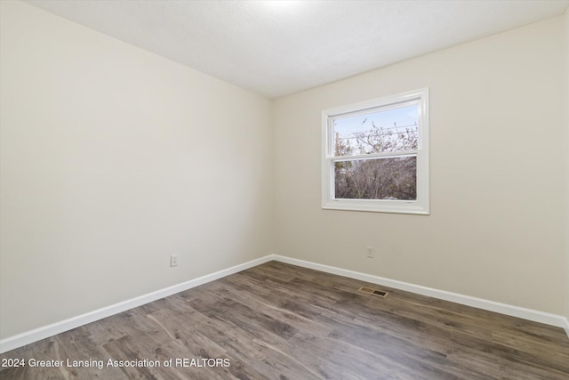 unfurnished room with wood-type flooring