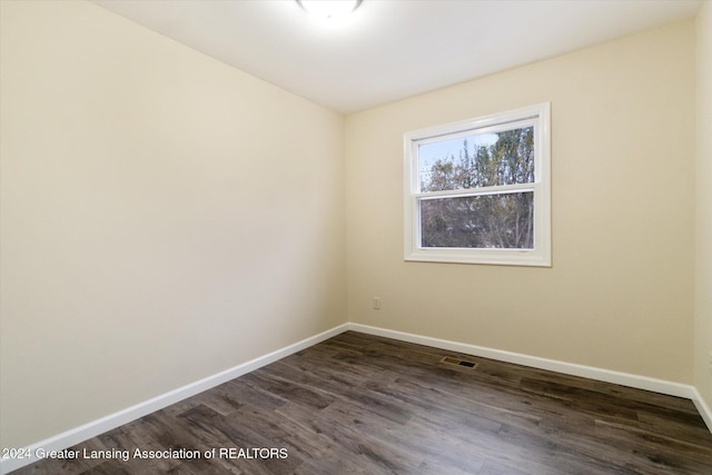 unfurnished room featuring dark hardwood / wood-style floors