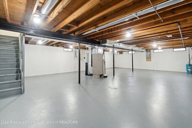 basement with electric panel and heating unit