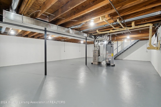 basement featuring heating unit and gas water heater