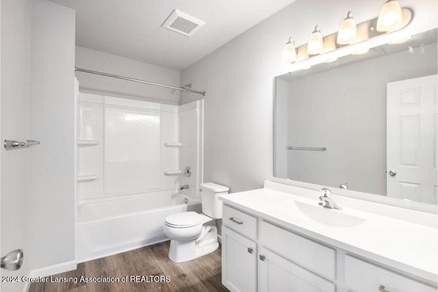 full bathroom with toilet, wood-type flooring, vanity, and bathing tub / shower combination