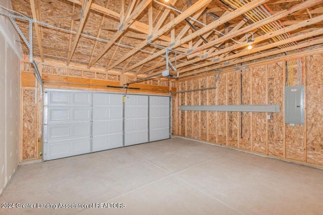 garage featuring electric panel and a garage door opener