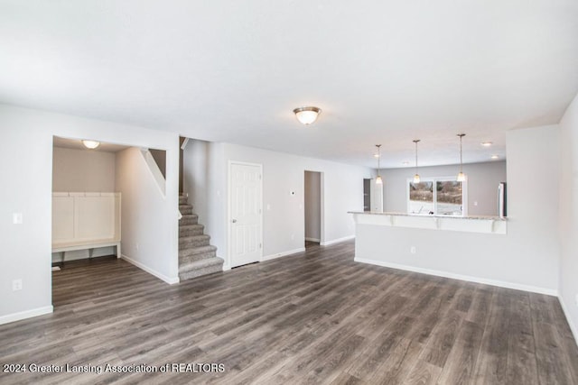 unfurnished living room featuring dark hardwood / wood-style flooring