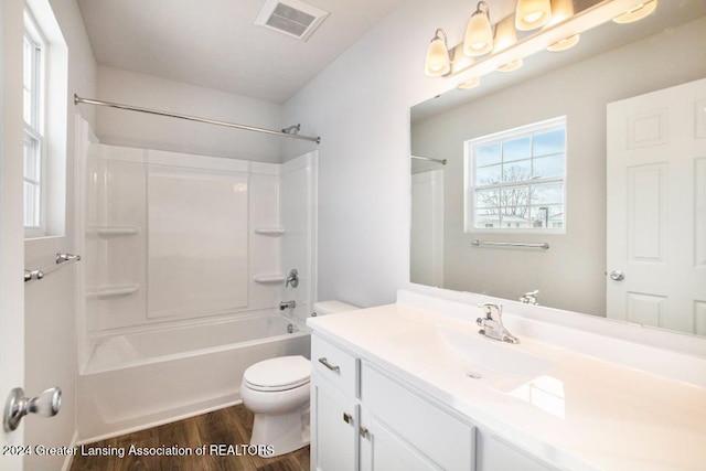 full bathroom with hardwood / wood-style floors, vanity, toilet, and shower / tub combination