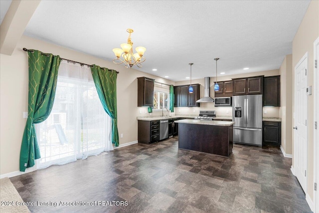 kitchen with wall chimney exhaust hood, dark brown cabinetry, stainless steel appliances, pendant lighting, and a center island