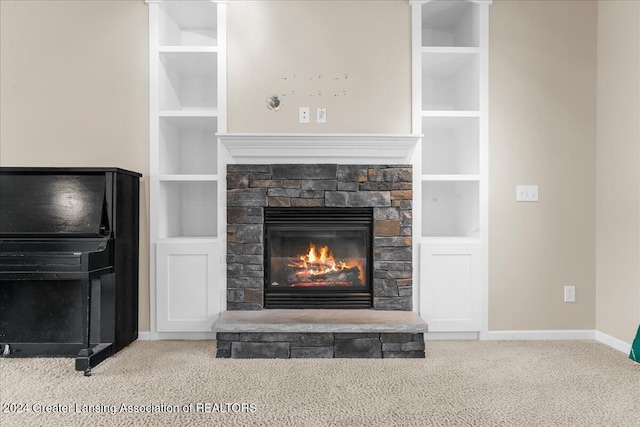 room details with built in shelves, a fireplace, and carpet