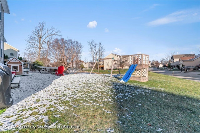 view of jungle gym featuring a lawn