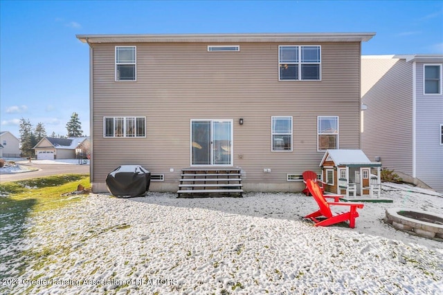 back of property with an outdoor fire pit