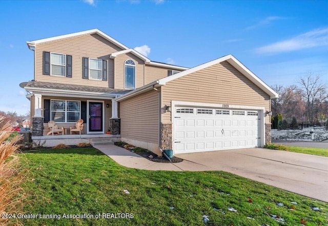 view of front property featuring a front yard and a garage