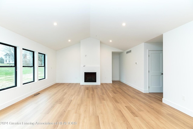 unfurnished living room with light hardwood / wood-style floors and vaulted ceiling