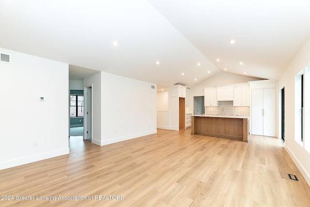 unfurnished living room with light hardwood / wood-style flooring and lofted ceiling