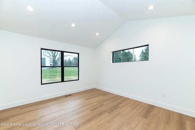 empty room featuring light hardwood / wood-style floors and lofted ceiling