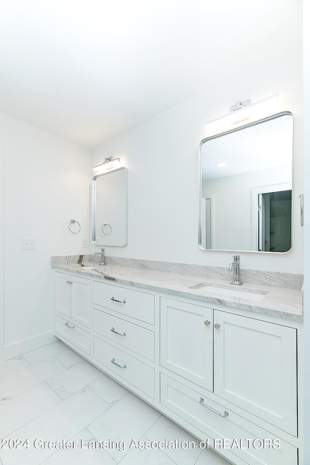 bathroom with tile patterned flooring and vanity