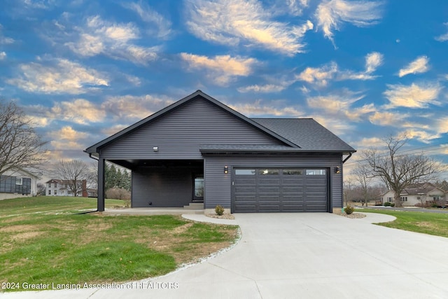 view of front of property featuring a front yard and a garage