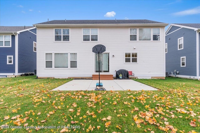 back of property with a yard and a patio area