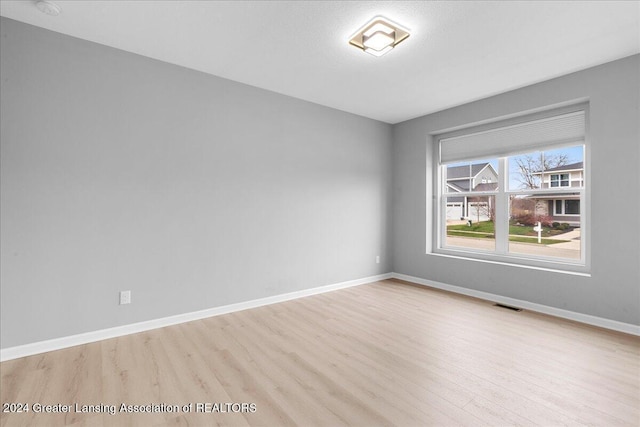 spare room with light wood-type flooring