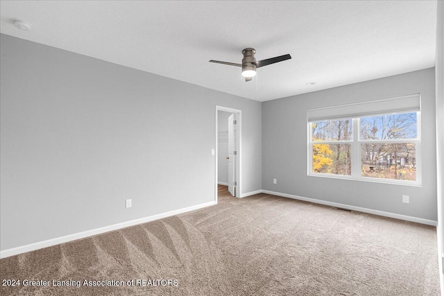 carpeted empty room with ceiling fan