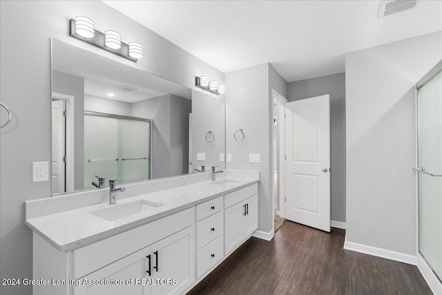 bathroom with vanity, wood-type flooring, and a shower with shower door