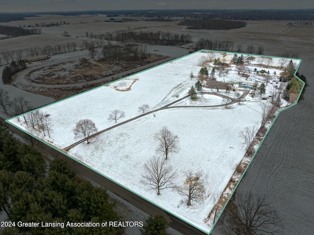 snowy aerial view featuring a rural view