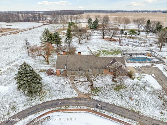 snowy aerial view featuring a rural view