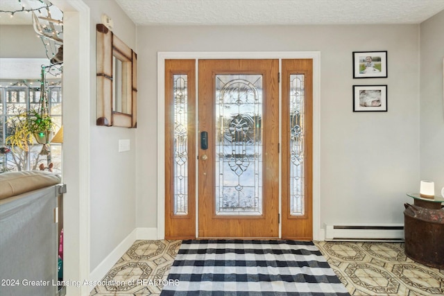 tiled entrance foyer featuring a textured ceiling, a baseboard radiator, and plenty of natural light