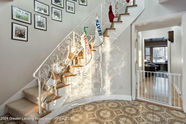 stairway with tile patterned flooring