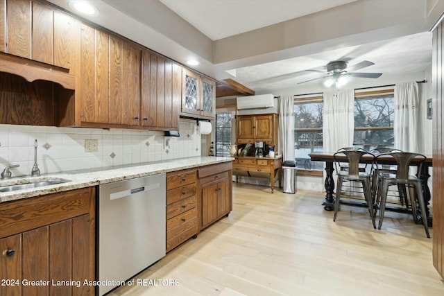 kitchen featuring backsplash, ceiling fan, a wall mounted AC, dishwasher, and light hardwood / wood-style floors