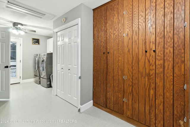 clothes washing area featuring washer and clothes dryer, ceiling fan, and cabinets