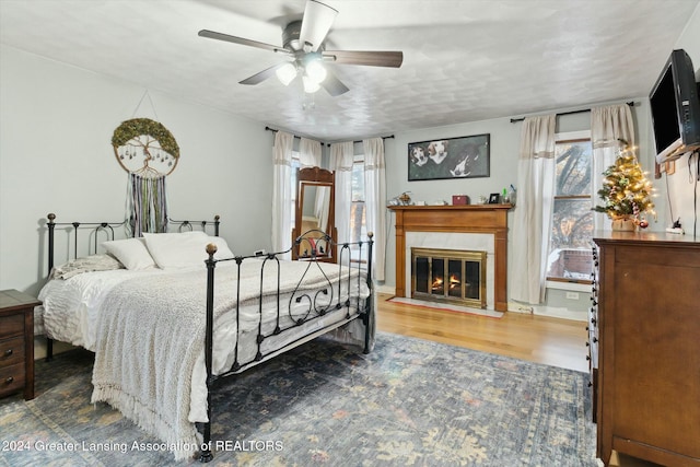 bedroom with hardwood / wood-style flooring and ceiling fan