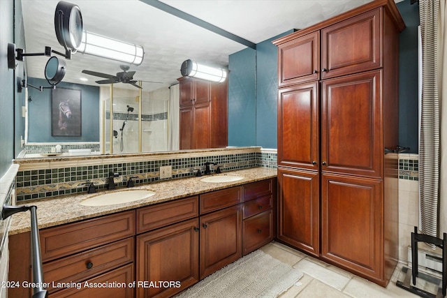 bathroom with ceiling fan, tasteful backsplash, tile patterned flooring, an enclosed shower, and vanity