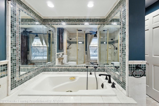 bathroom featuring separate shower and tub, toilet, and ornamental molding