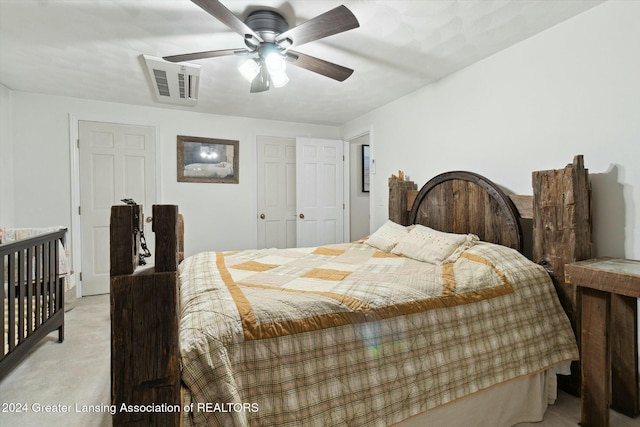 bedroom with ceiling fan, a closet, and light colored carpet