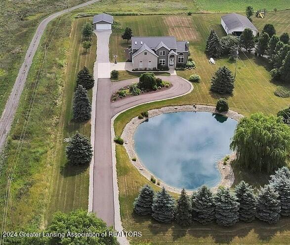 birds eye view of property with a water view