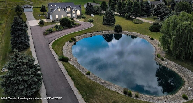 birds eye view of property with a water view