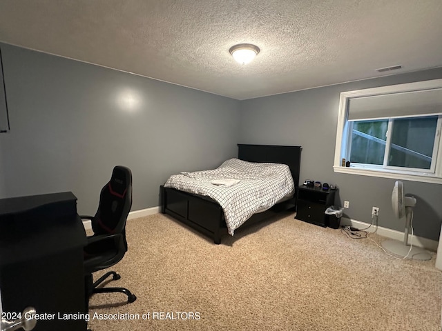 bedroom featuring carpet and a textured ceiling