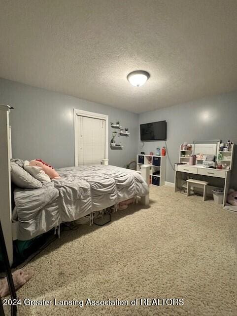 carpeted bedroom featuring a textured ceiling