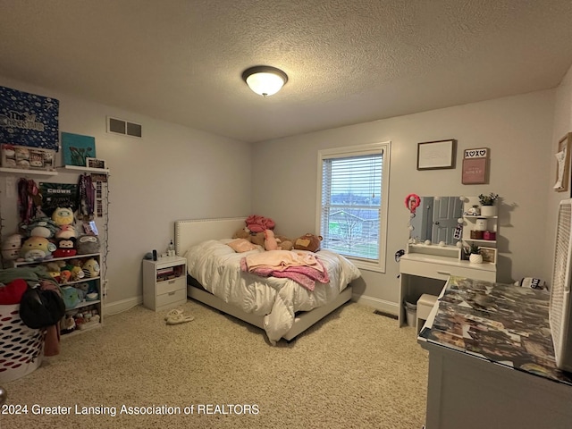 carpeted bedroom featuring a textured ceiling