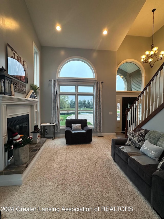 living room featuring carpet, a chandelier, and high vaulted ceiling