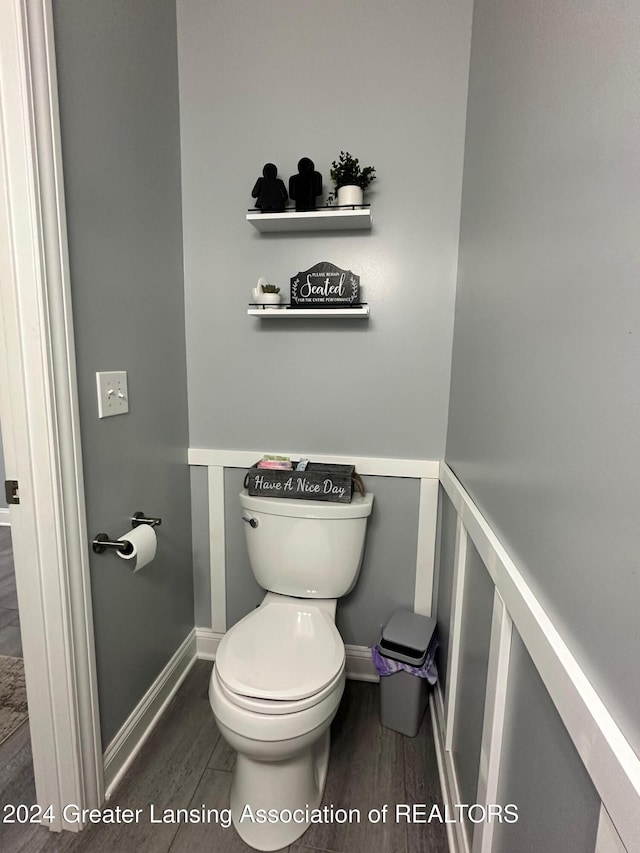 bathroom featuring hardwood / wood-style flooring and toilet