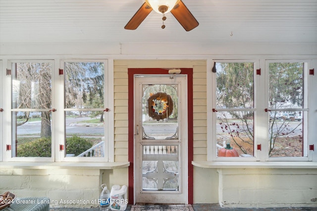 interior space with ceiling fan