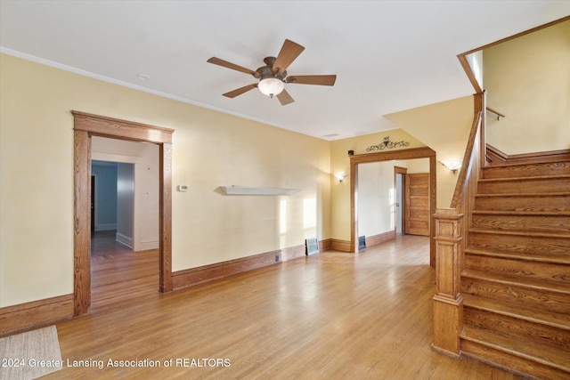 unfurnished living room featuring ceiling fan, light hardwood / wood-style floors, and crown molding