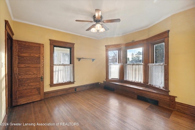 unfurnished room with ceiling fan, wood-type flooring, and ornamental molding