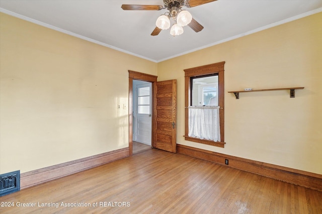 spare room with ceiling fan, ornamental molding, and light hardwood / wood-style flooring