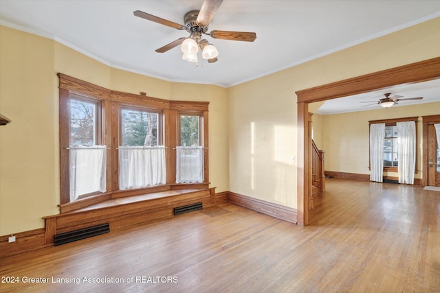 unfurnished room featuring ceiling fan, hardwood / wood-style floors, and ornamental molding