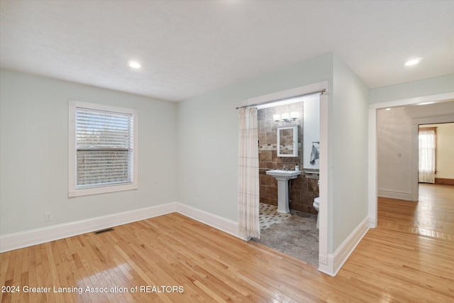 empty room with light wood-type flooring and sink